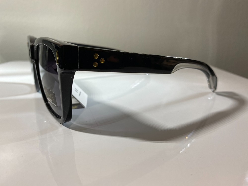 Women's classic style sunglasses with black frame and purple tinted lenses