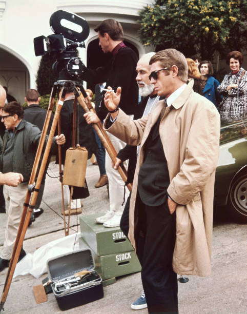 Steve McQueen in sunglasses smoking cigarette discusses a scene wi- Old Photo