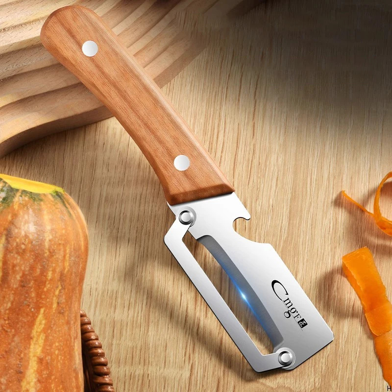 Stainless steel peeler with wooden handle for peeling and slicing fruits