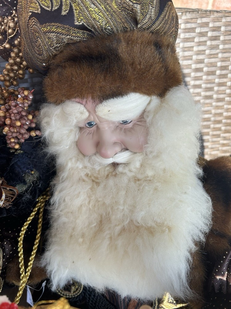 Vintage Santa Claus Brown Velvet attire. Face is hard along with his hands.