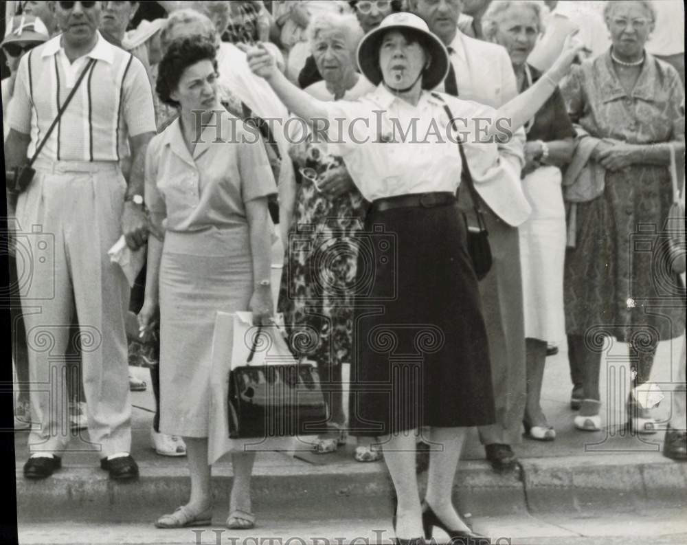 1959 Press Photo Mrs. Grace Weichelt directs traffic as pedestrians wait behind