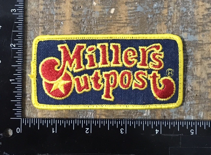 Vintage MILLERS OUTPOST Apparel Clothing Store Advertising Logo Patch Defunct