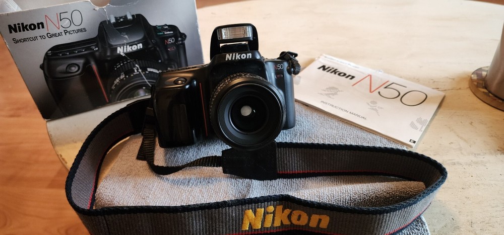 nikon 35mm slr film camera with lens