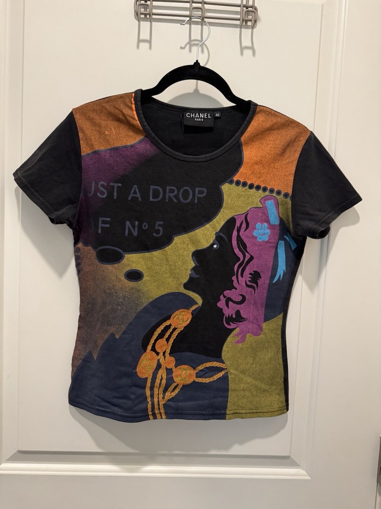 Chanel black graphic t-shirt featuring a stylized illustration and text Size S