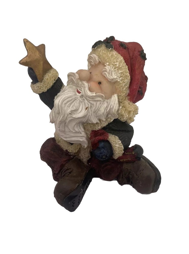Santa Holding a Star Figurine
