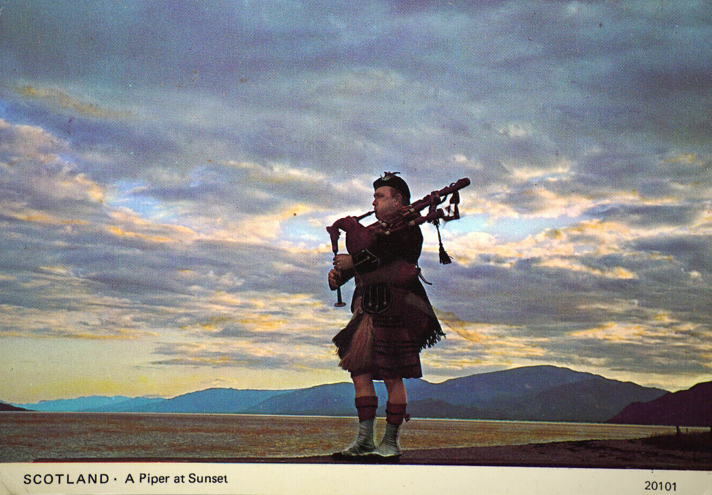 Postcard A piper at Sunset Scotland Hills Loch Scottish Highlands Kilt Bagpipes