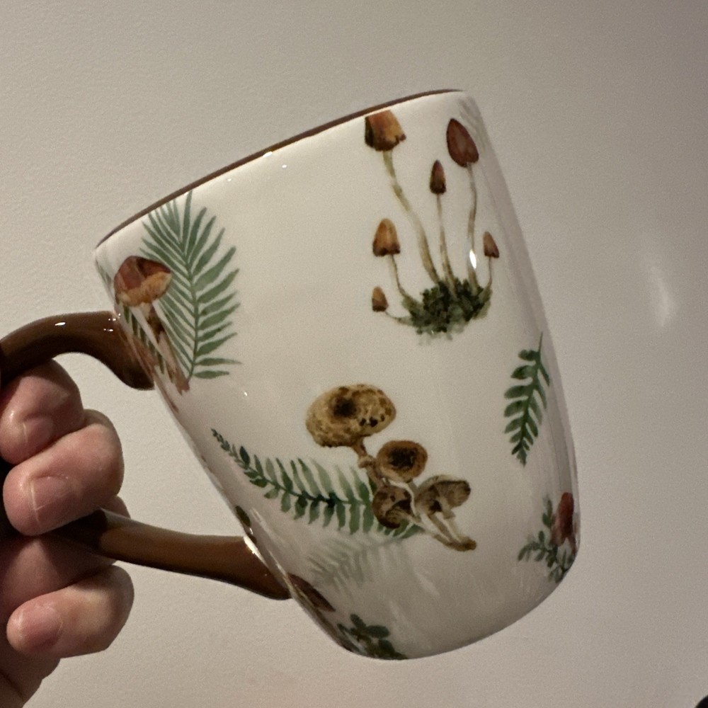 Woodland-themed coffee mug with ferns and mushrooms brown handle
