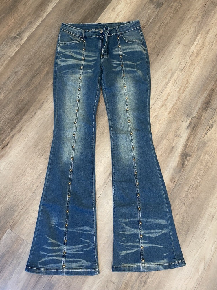 Low-rise studded flared jeans with metallic accents for edgy style