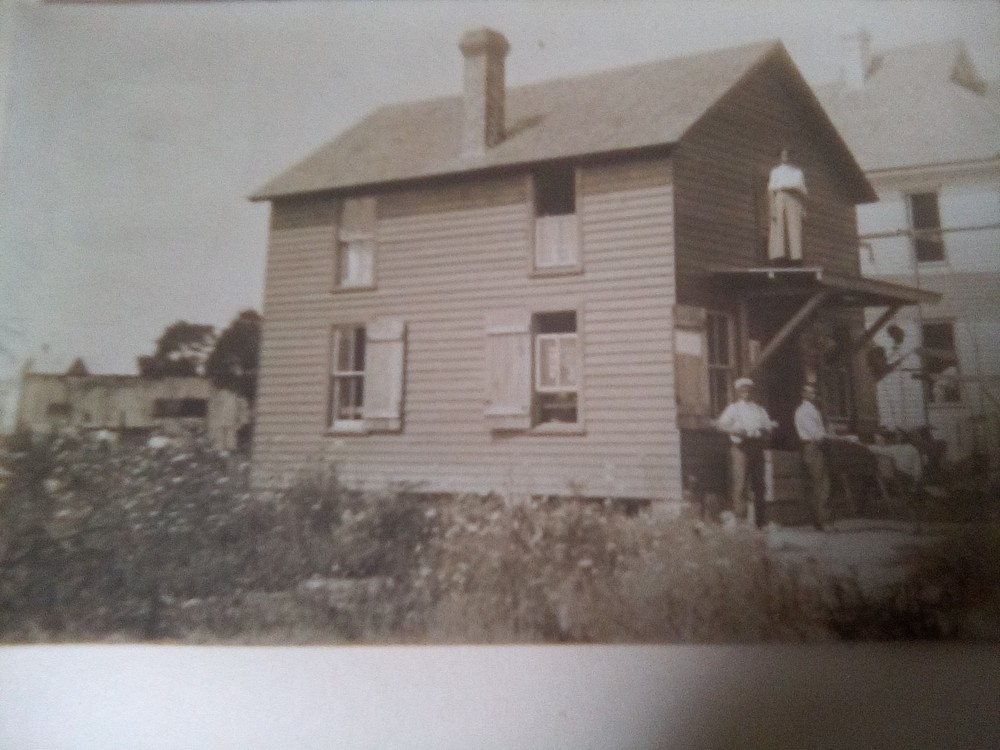postcard Black family scene around house man playing guitar posted 1909