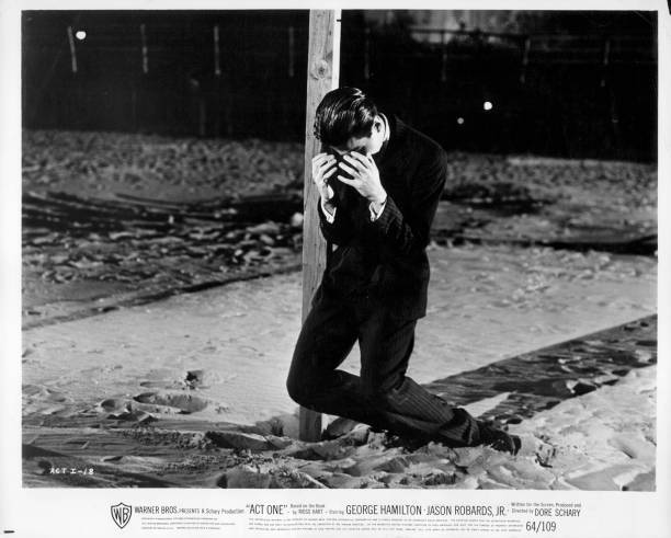 George Hamilton holds face before falling to the ground in Act One- Old Photo