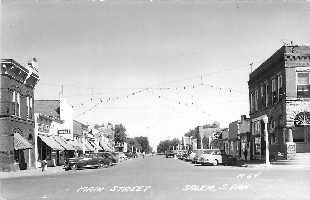 1940s Salem South Dakota Main Street autos Drugs Cook M-64 RPPC Postcard 25-7917