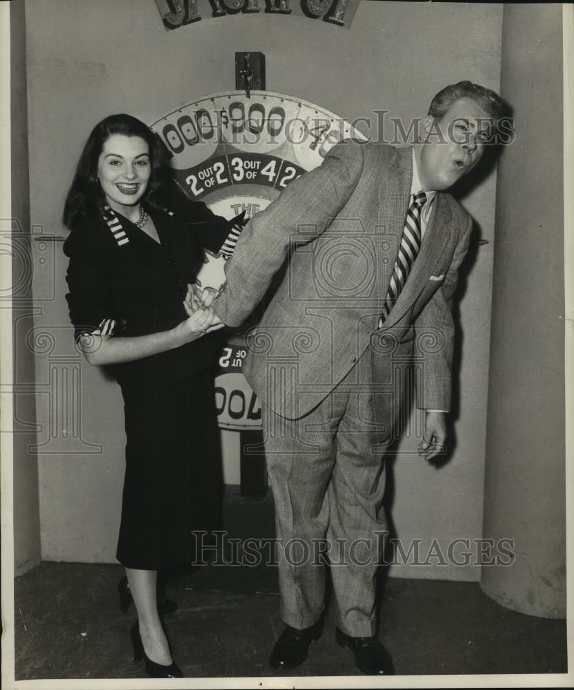 1951 Press Photo Miss America 1951 Yolande Betbeze twists arm of man beside game