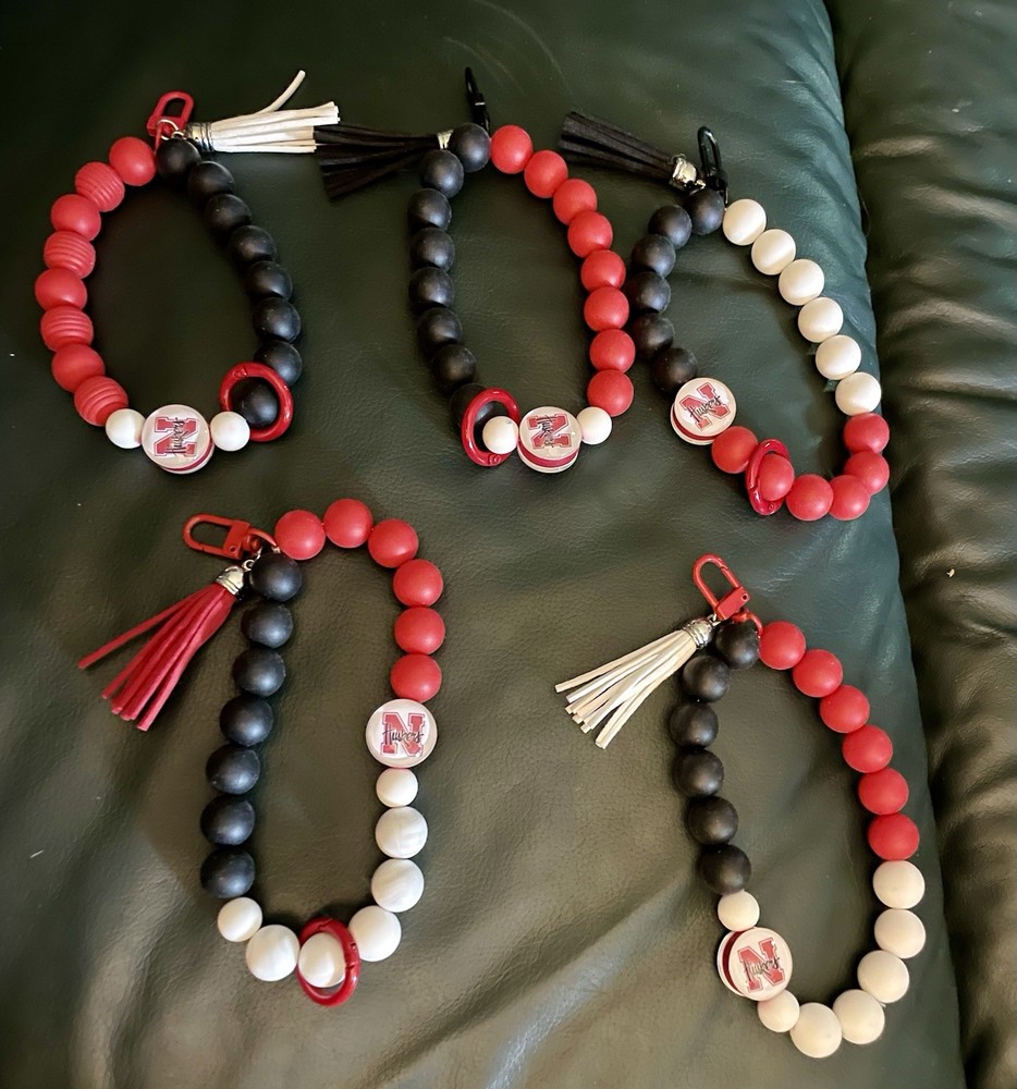 Handmade silicone NFL team and Nebraska wristlet keychain per each