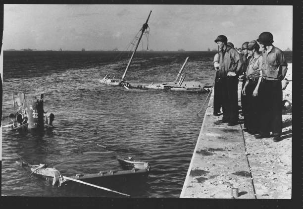 United States Coast Guards look at the shipwreck of a Japanese cra- Old Photo