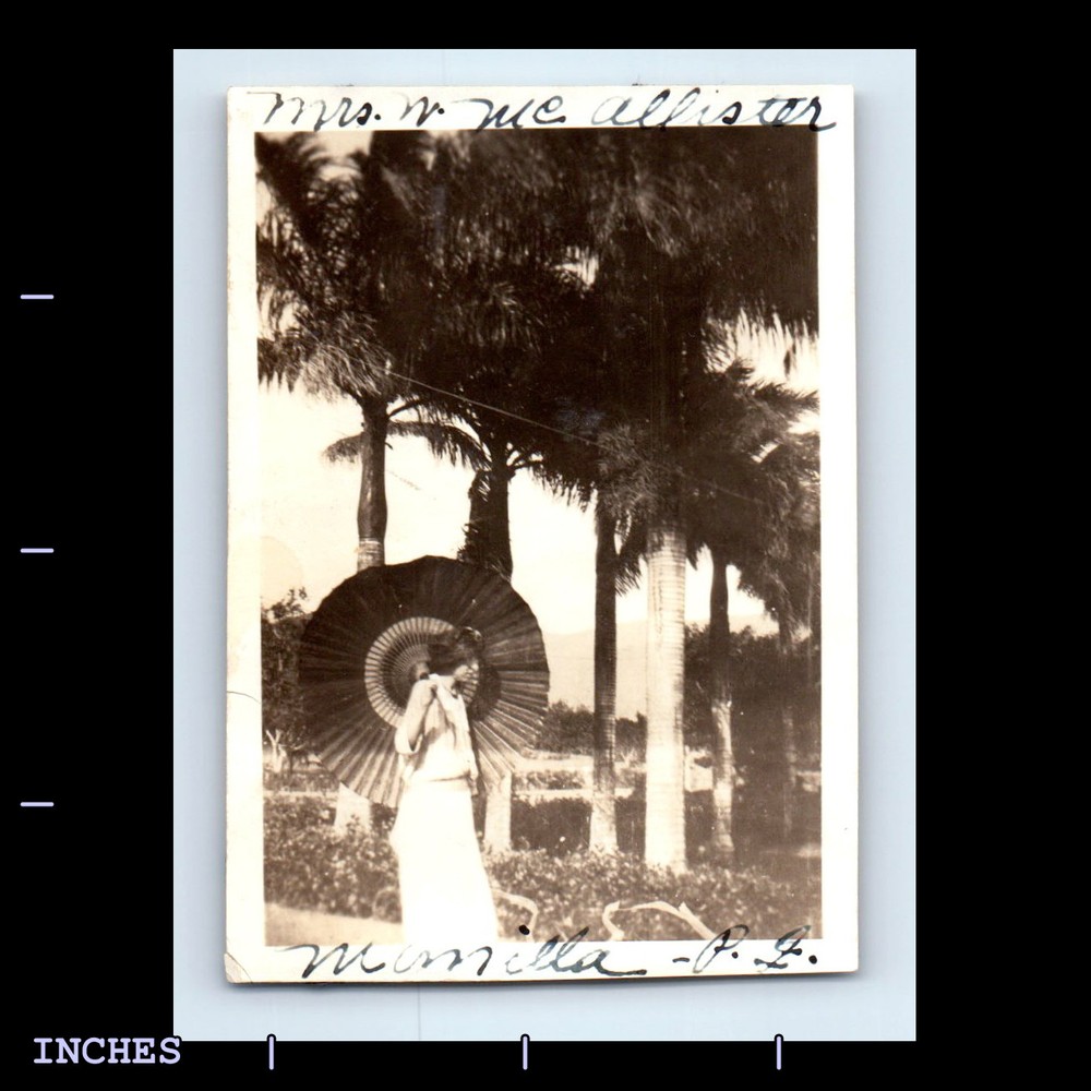 Vintage black and white photo of woman with umbrella in Manila Philippines  
