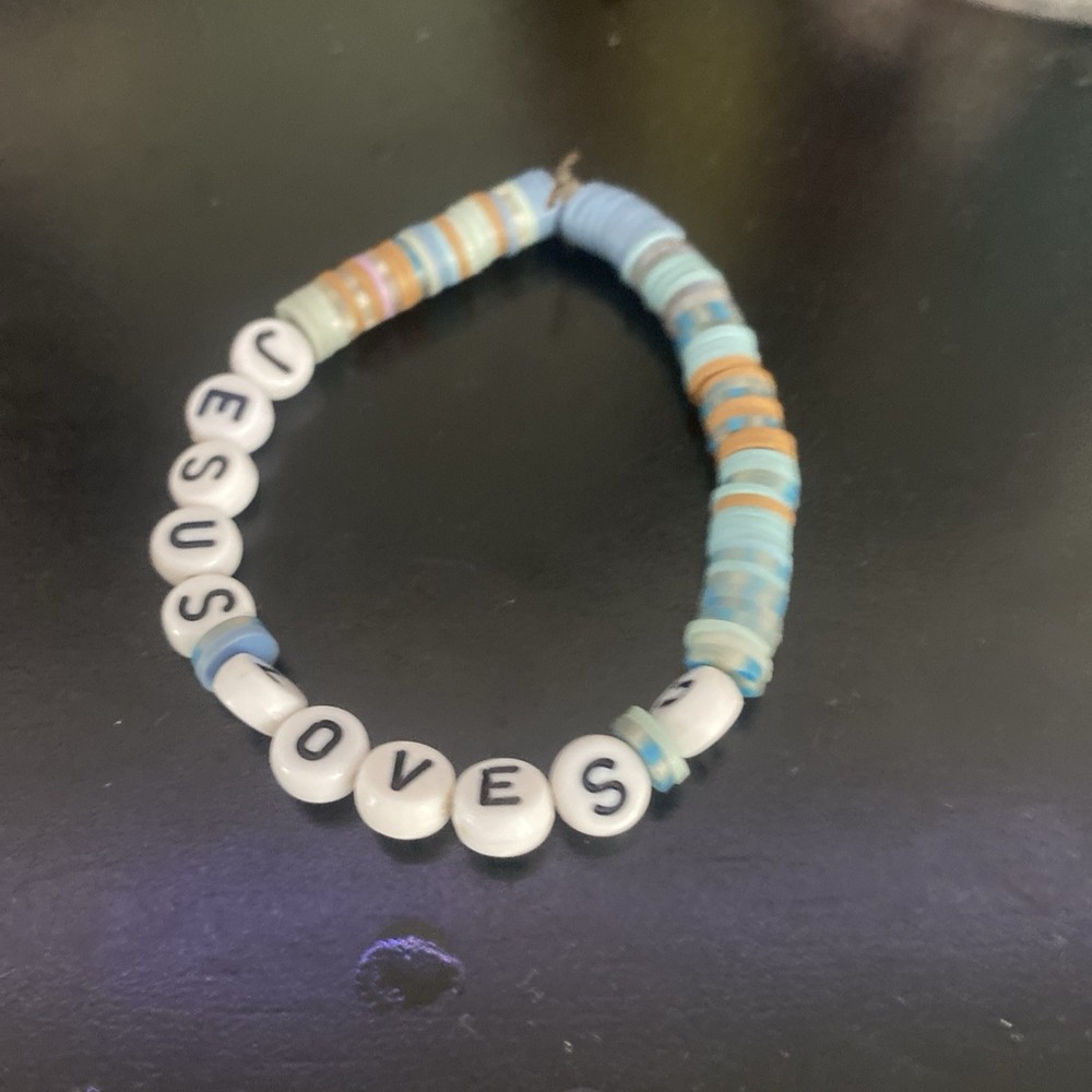 Handmade clay bead bracelet with unique artisan charm