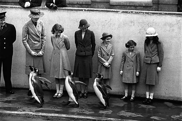 Princess Elizabeth and her sister Princess Margaret look at the pe- Old Photo