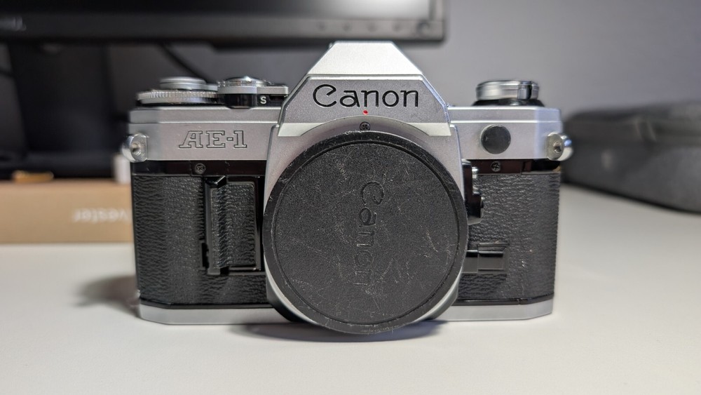 Canon AE-1 analog 35mm film SLR camera with  zoom/tele lens