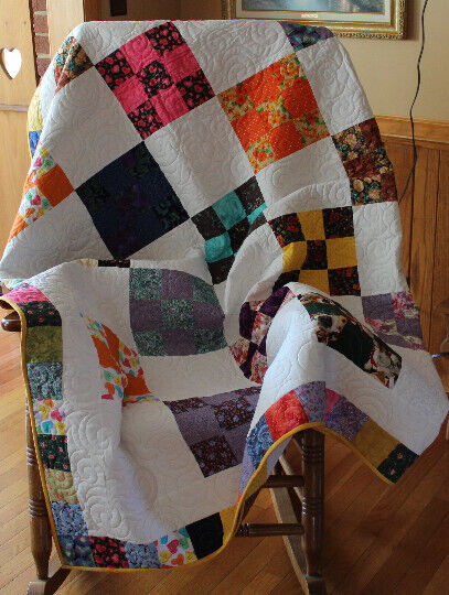 Beautifully hand crafted nine-patch  quilt that is cheerful scrappy style