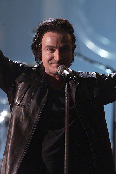 Bono and U2 play at the finale of the Brit Awards at Earls Court 2- Old Photo 2