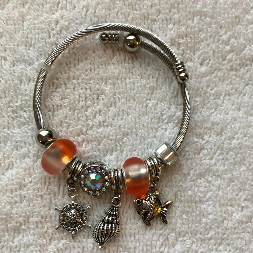 Women’s gold-accented open bracelet with colorful acrylic bead charms