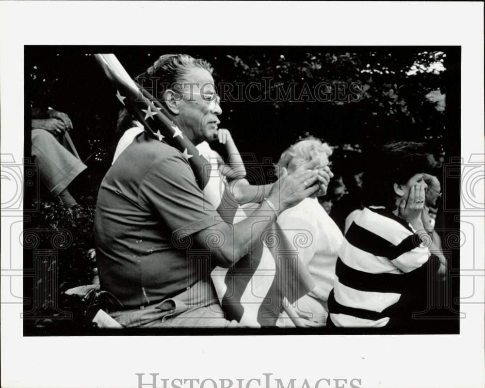 Press Photo Man holding American Flag at an event - lra37179