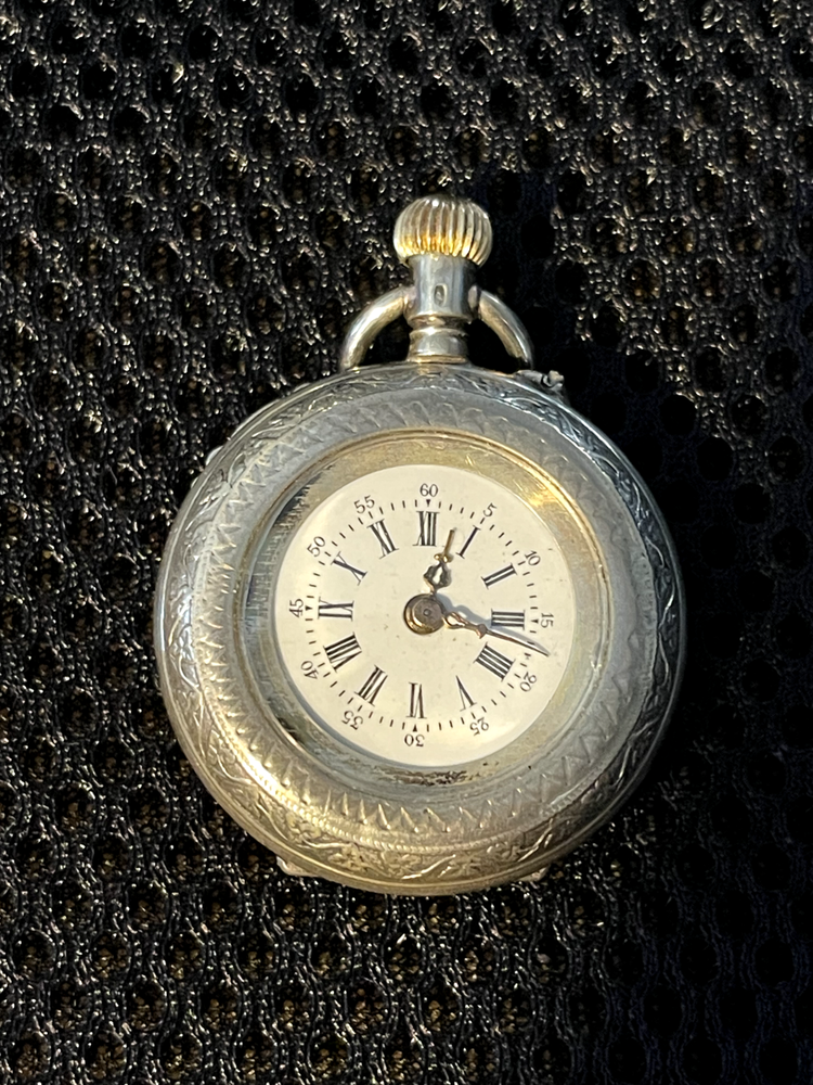 Antique Chased Swiss, silver, cylinder lever set ladies pocket watch.
