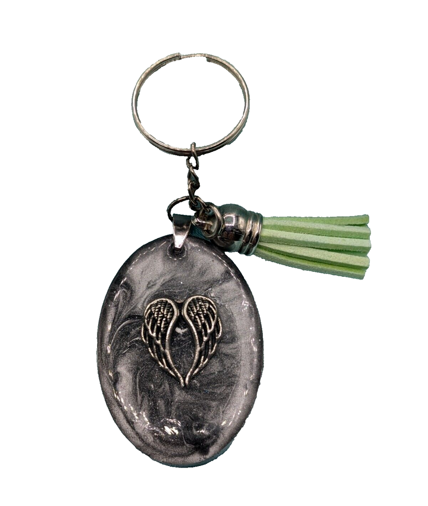 Oval silver resin keychain w/angle wings charm and a green tassel