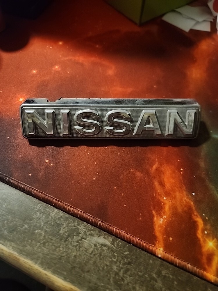 Nissan 720 Pickup Truck Front Grill Emblem 1979-1982 Part 62890-10W00