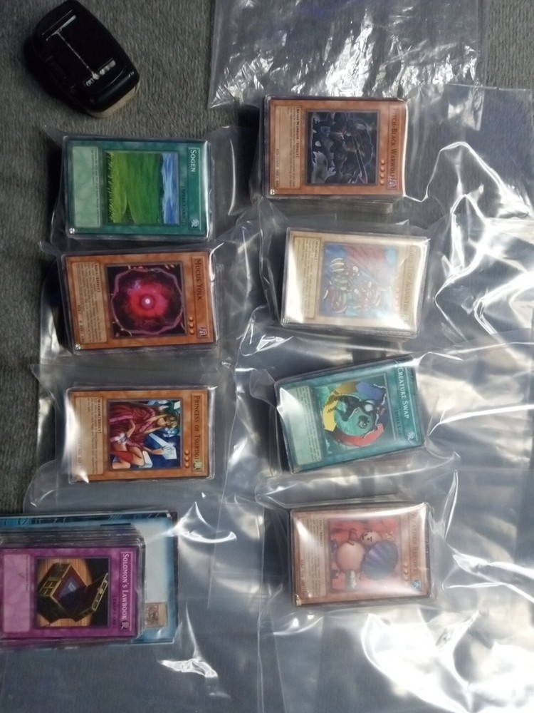 There Is 7 Stack Of 100 Yu-gi-oh Card's