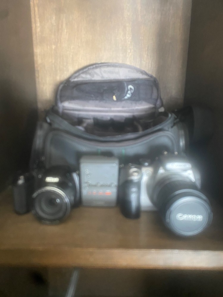 Canon DS6041 with charger & Nikon CoolPix L330 Cameras. Comes in carrying bag