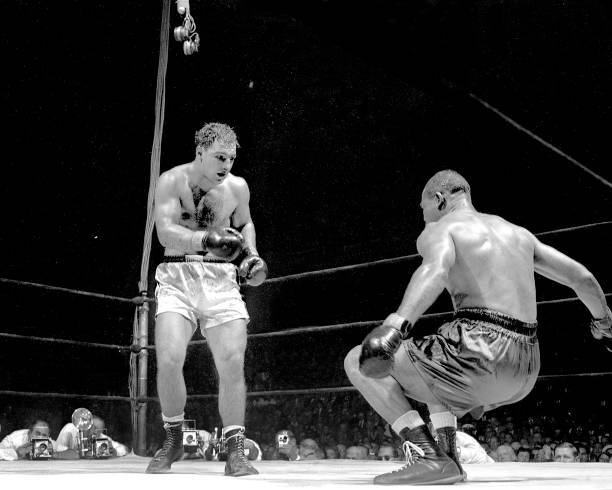 Rocky Marciano has Joe Louis in a sitting position at Madison Squa .. Old Photo